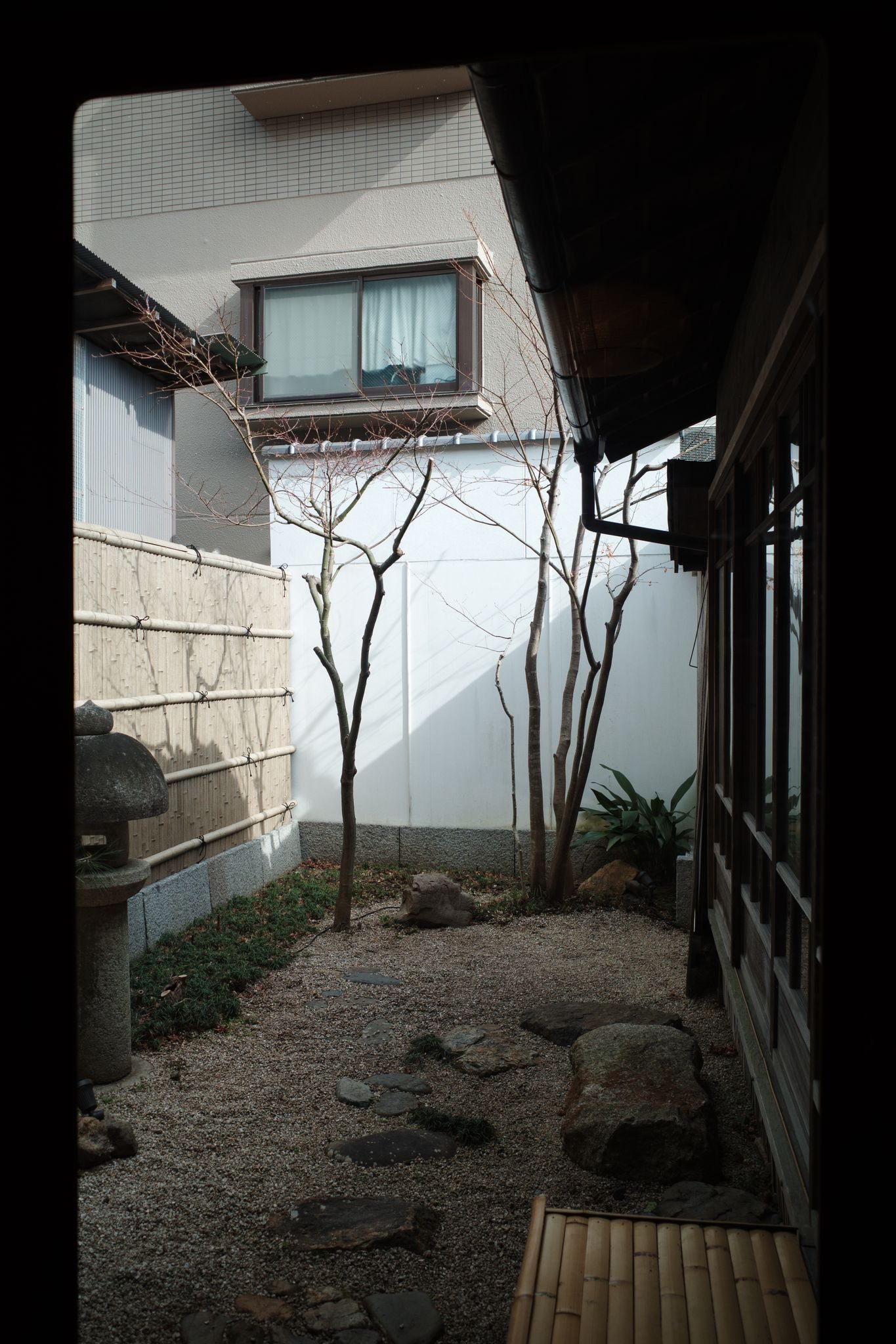 Peaceful courtyard in Kyoto with Zen garden and traditional architecture.